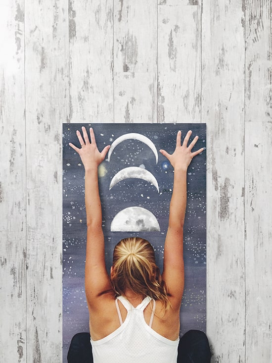 Woman reaching for the moon on personalized yoga mat