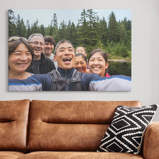 Outdoor family photo on stretched canvas behind couch