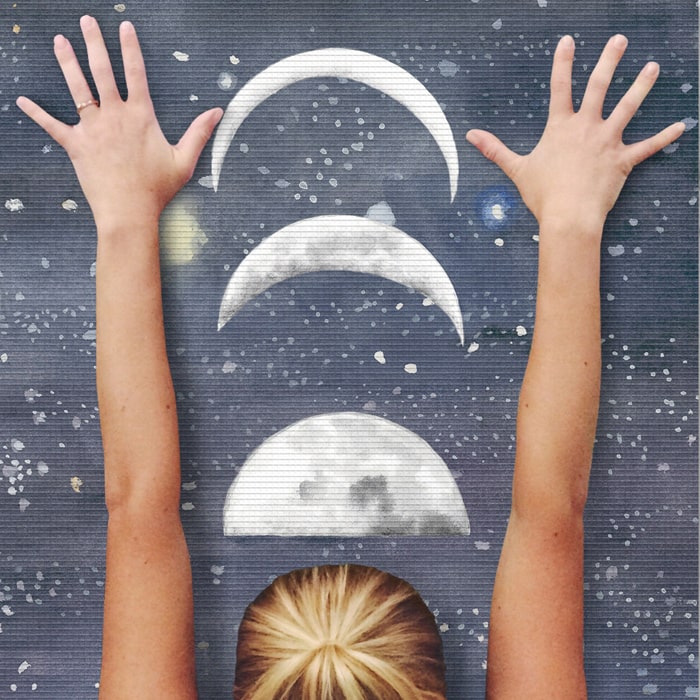 Woman reaching the moon on personalized yoga mat