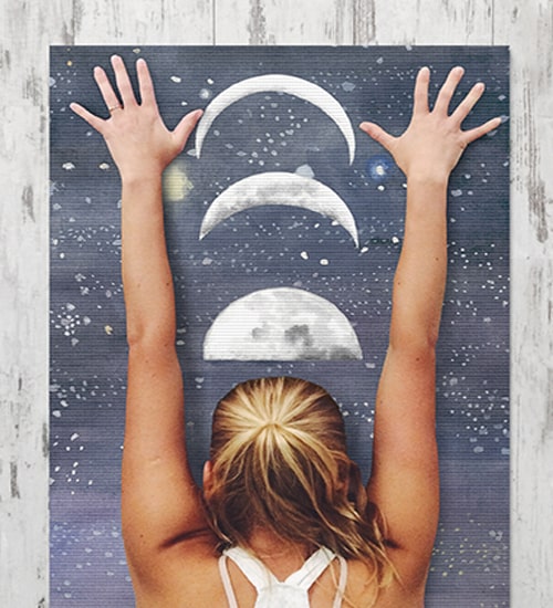 Woman reaching the moon on personalized yoga mat