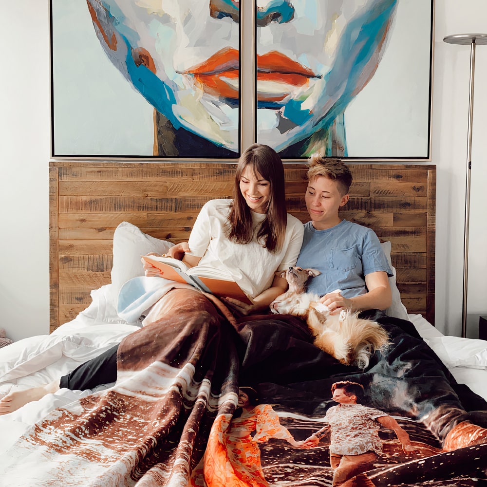 Couple in bed with custom fleece blanket