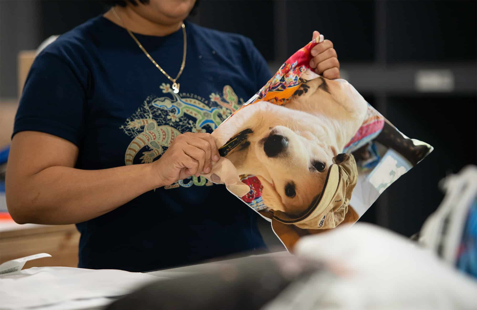 worker assembles a printed pillow