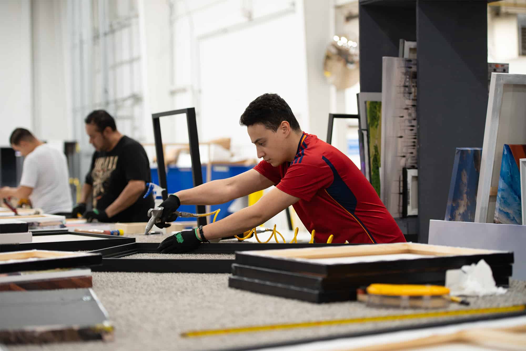 Reducing Factory Overhead Costs | Sensaria person making a canvas