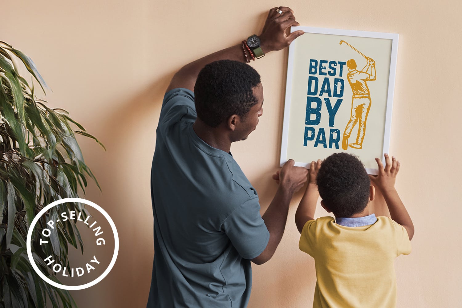 Ecommerce Holiday Calendar | Sensaria Long shot of young father and little son hanging handmade artwork on wall