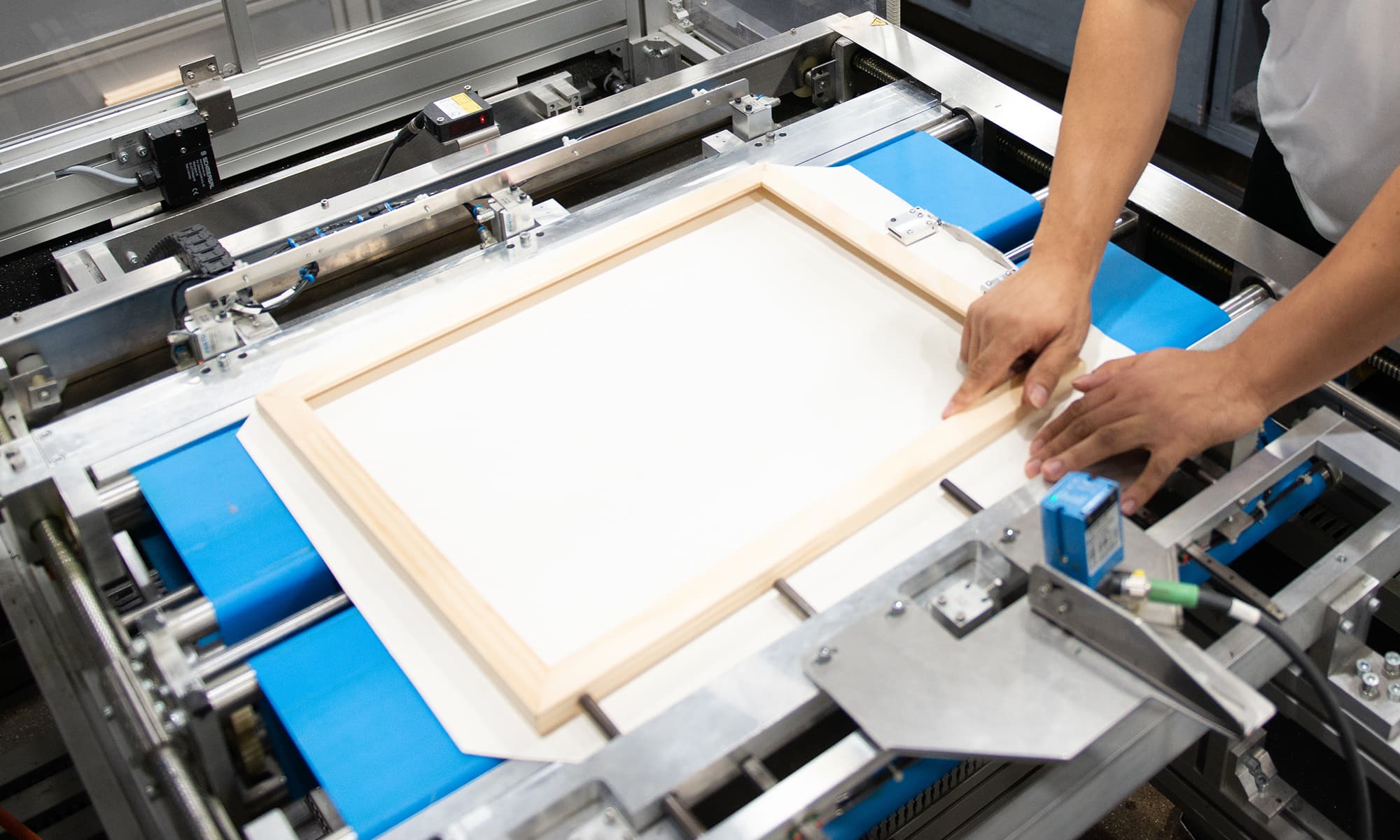 worker loads a canvas print